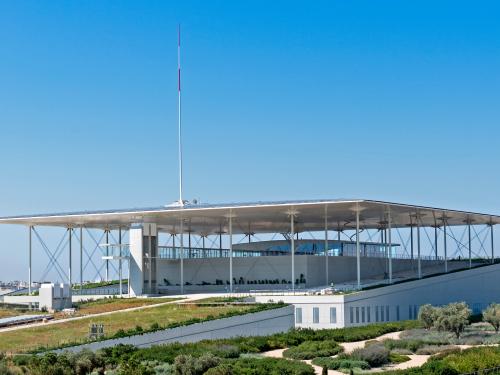 Modern building with a flat roof and vegetated areas on a green roof